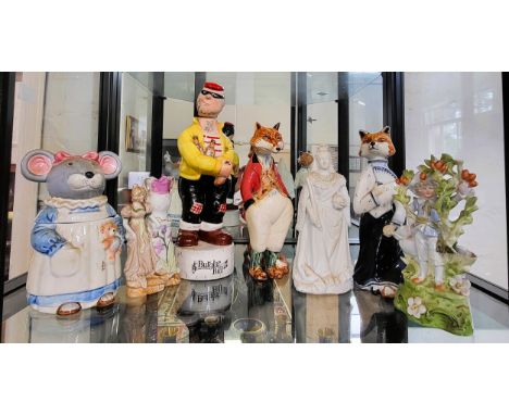 A bisque figure of Queen Victoria 21cm, pair of Rye Pottery foxes 23.5cm, Burglar Bill musical bottle with stopper 31cm, thre