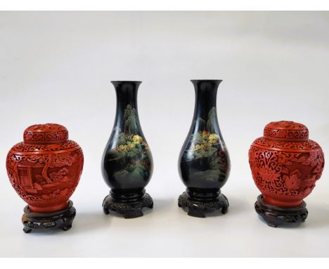 A pair of cinnabar lacquer ginger jars with landscape design and wood stands 20cm, and a  pair of black lacquer bottle vases 