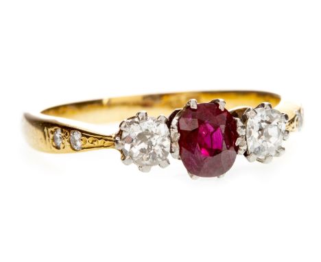 RED GEM AND DIAMOND THREE STONE RING, the central faceted oval red gem 5mm long and flanked by two old cut diamonds totalling