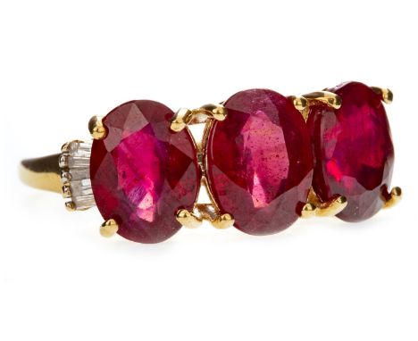 RUBY AND DIAMOND DRESS RING, set with three oval rubies flanked by tapered baguette cut diamonds to either shoulder, the diam