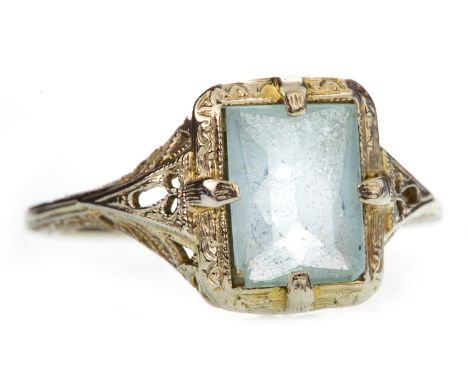 EARLY TWENTIETH CENTURY BLUE GEM SET RING, set with a faceted blue gem 8mm long, with openwork filigree detail to the gallery