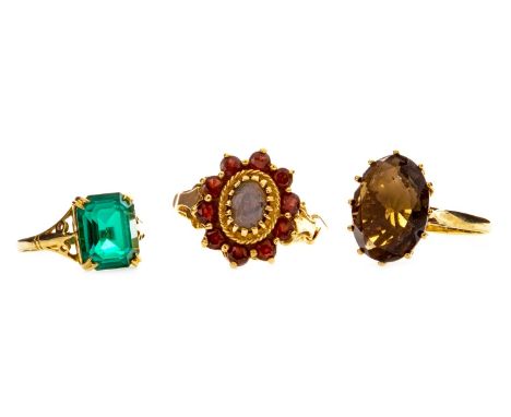 GREEN GEM SET RING, the four claw mounted green gem on pierced trifurcated shoulders, in nine carat gold, size K 1/2; along w