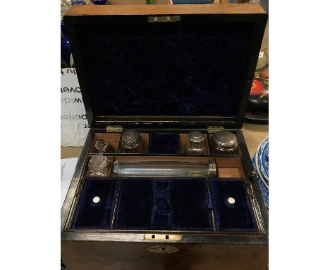 A Victorian burr walnut and mother of pearl inlaid travelling vanity case, fitted with various bottles, 30.5 cm wide x 22.5 c