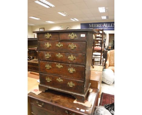 An 18th Century elm and walnut chest of small proportions, the single piece top over two short and four long graduated drawer