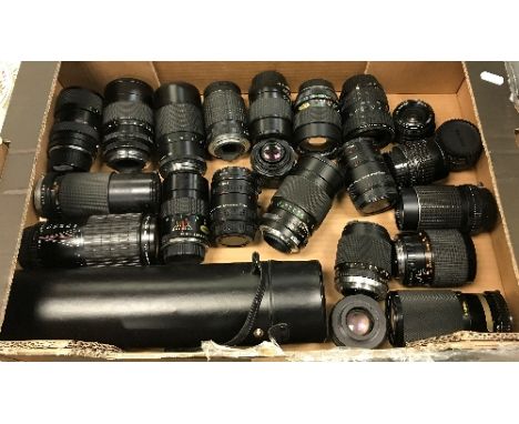 A box containing 22 various camera lenses including a Sigma Super Tele multi-coated 1:5.6F=400mm, Soligor Tele Auto, Pentax -