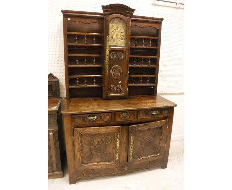 A 19th Century Breton elm and fruitwood dresser, the three tier boarded plate rack with centrally mounted clock with painted 