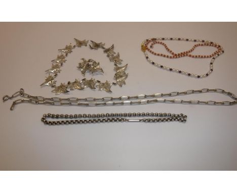 A silver chainlink necklace, 1.56 oz, a plated "miracle" folliate decorated necklace and matching brooch, a white metal chain