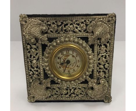 A Victorian mantel clock with pierced plated decoration enclosing the dial with fairy and dragonfly decoration in the Aesthet