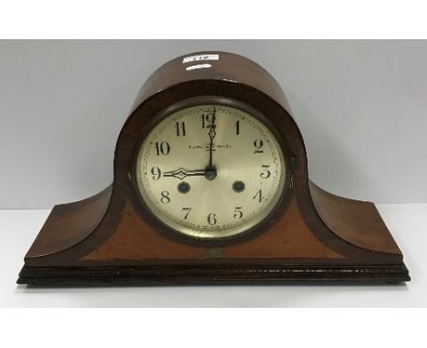 An early 20th Century mahogany cased dome top mantel clock, the silvered dial with Arabic numerals inscribed "Exd by The West