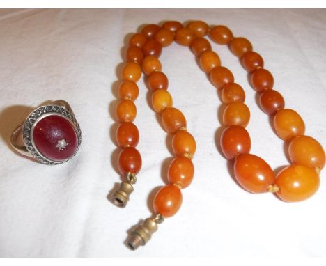 A graduated bead amber necklace, approx 39.5 cm long,approx 14.5 gms  together with an amber set dress ring inset with seed p