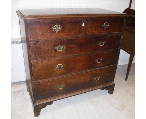 A 19th Century oak chest, the plain top with applied moulded edge over two short and three long graduated drawers with brass 