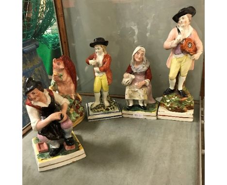 An early 19th Century Pearl ware pottery figure of a hurdygurdy player (circa 1810-20), 23 cm high, another early 19th Centur