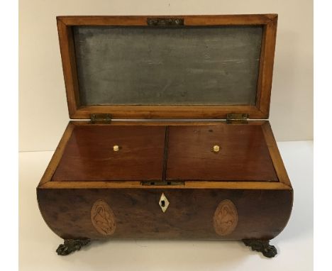 A Regency burr yew and marquetry inlaid tea caddy with brass ring handles, raised on lion's paw feet, 31 cm wide x 16 cm deep