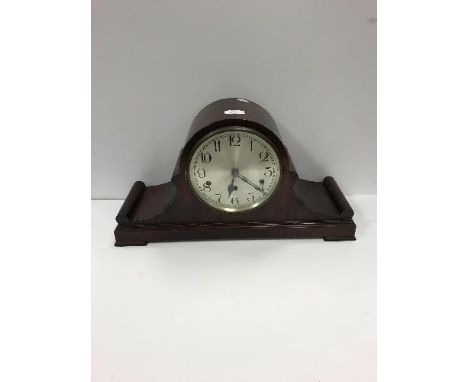 An early 20th Century mahogany cased dome top mantel clock with silvered dial and Arabic numerals 27 cm high x 52 cm high tog
