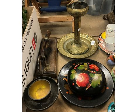 A Continental Arts &amp; Crafts brass candlestick, 28 cm high, a brass alms dish with central stylised rose decoration, 25 cm