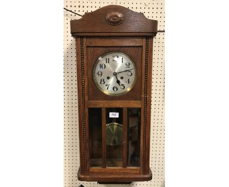 A 1930s oak cased drop dial wall clock, the silvered dial with Arabic numerals 78 cm high x 33 cm wide