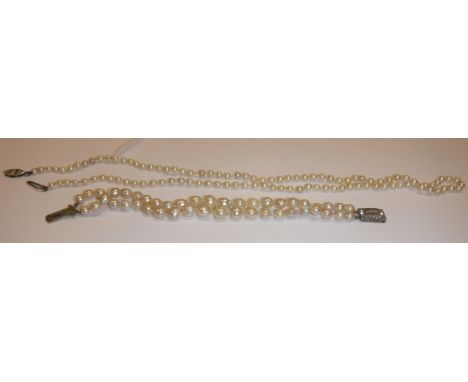 A seed pearl single strand necklace, the 9 carat white gold navette form clasp set with a single diamond chip, 53 cm long, to
