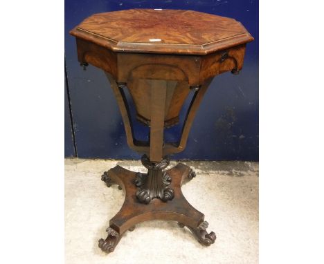 A Victorian figured mahogany octagonal trumpet shaped work table on double lyre supports to scroll carved pedestal and platfo