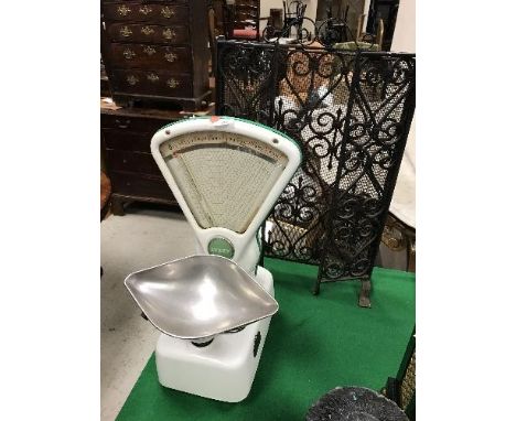 A set of vintage enamelled Avery 2lb shop scales, 54 cm high and a wrought iron and wirework three section spark guard, 77 cm