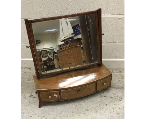 A Regency mahogany toilet mirror, the rectangular plate on reeded supports to a rosewood and crossbanded satinwood strung thr