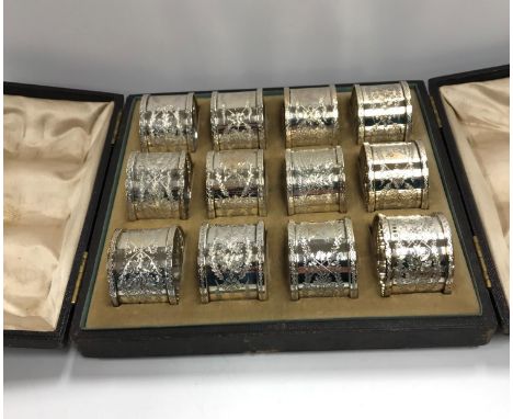 A set of twelve Victorian silver and engraved napkin rings, each with family motif of gauntlet and crossed axes, No'd. 1-12 (