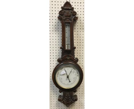 A circa 1900 oak cased barometer thermometer, 71.5 cm high and a Victorian mahogany writing slope 45 cm wide