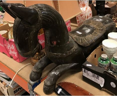 A 20th Century Indian brown lacquered and jewelled figure of a recumbent horse with saddle, 84 cm long x 47 cm high, together