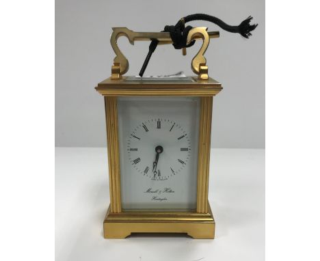 A brass cased carriage clock, the English movement with enamelled dial and Roman numerals inscribed "Morrell &amp; Hilton, Hu