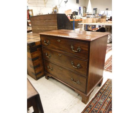 An early 19th Century mahogany chest, the top with applied moulded edge over three long drawers with ornate brass swan neck h