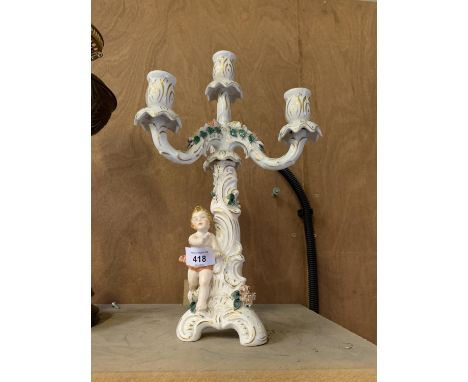 A CONTINENTAL HARD PASTE PORCELAIN FIGURAL CANDLESTICK 