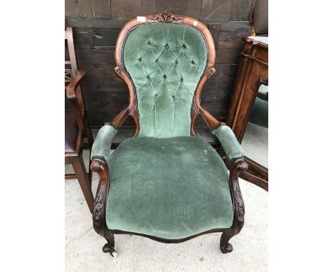 A CARVED MAHOGANY BUTTON BACK ARMCHAIR 