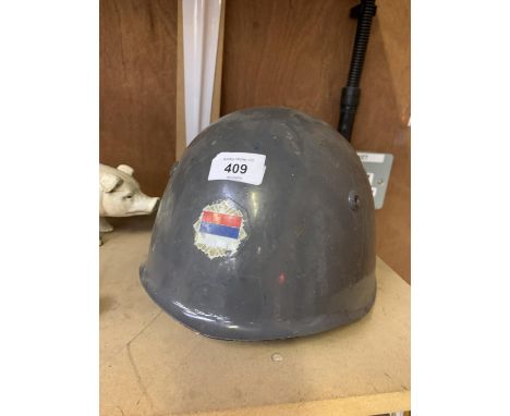 A VINTAGE METAL ARMY HELMET WITH SERBIAN FLAG 