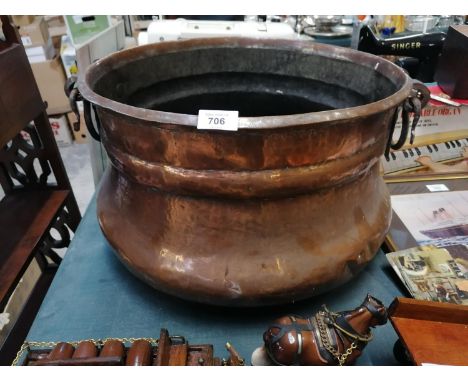 A VINTAGE BEATEN COPPER TWIN HANDLED COAL BUCKET 