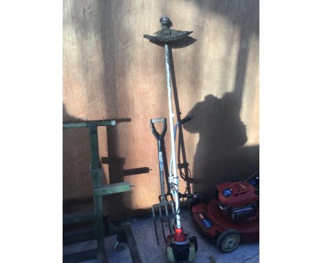 A KAWASAKI TH43 PETROL STRIMMER AND A GARDEN FORK 