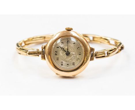 An early 20th Century ladies wristwatch, with an expandable bracelet strap, engine turned face, total gross weight 19.7grams 