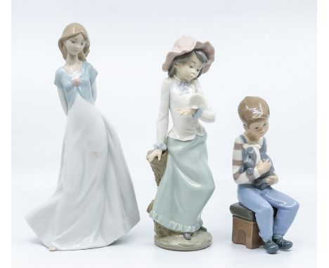 Three Nao figures, two young ladies and a boy with a dog