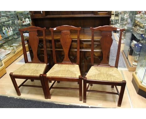 A set of six mahogany rush seated dining chairs, in the manner of Thomas Chippendale, hand crafted, together with a table (7)