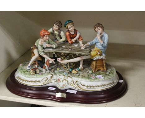 A large Capodimonte figure on stand of four Italian boys playing card The Beggars&nbsp;