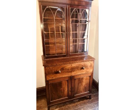 *** ITEM LOCATION BISHTON HALL*** A late George III mahogany bookcase secretaire, circa 1820, moulded pediment above two pane