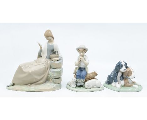 Three Nao figures, boy playing flute, pair of dogs, a lady reading a note