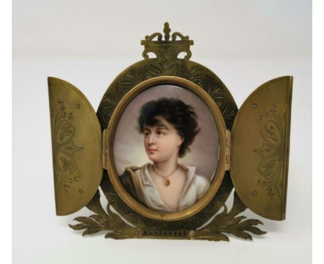 A 19th century Italian porcelain miniature portrait of a Neapolitan girl, in cut and engraved brass strut frame with hinged d