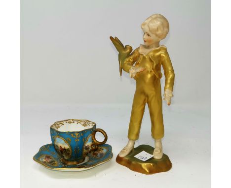 A Royal Worcester figure, 'The Parakeet'; a Coalport cabinet cup and saucer with hand painted vignettes against a turquoise a