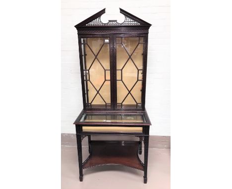 A late 19th century mahogany full height display/bijouterie cabinet in the Chippendale style with extensive blind fret decora