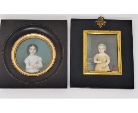 A 19th century half length miniature portrait of a girl holding a ball, diameter 6.5 cm; and an other; ebonised frames 