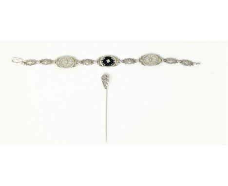 An Art Deco white metal filigree oval link bracelet stamped '14K' set with 3 small diamonds, 8gm,  and a similar stick pin (s