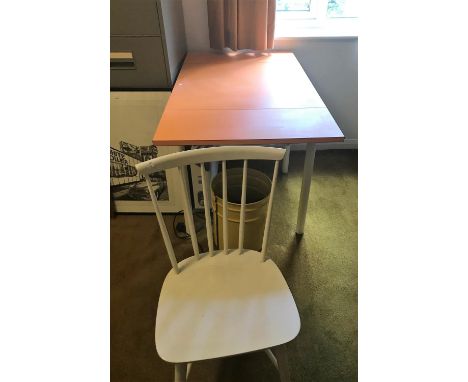 An orange drop leaf kitchen table and 2 chairs; a light oak writing table 