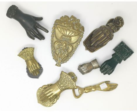 A Victorian cast iron hand as paperweight;  similar door knocker; a white metal fist shaped vesta case related items 