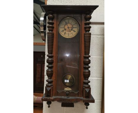 A Victorian Vienna wall clock in walnut case, with striking spring driven movement 