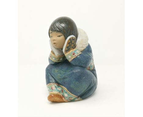 A Lladro figure of an Inuit girl sitting resting head on hands 
