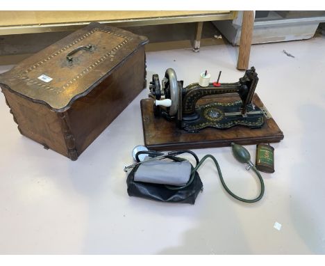 A Victorian Jones hand operated sewing machine in inlaid case; a vintage blood pressure set 